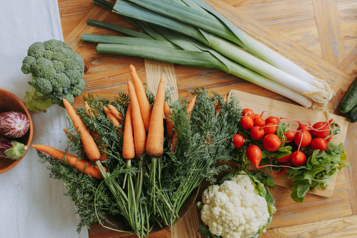A table of whole foods — vegetables, legumes, eggs, olive oil and fruit