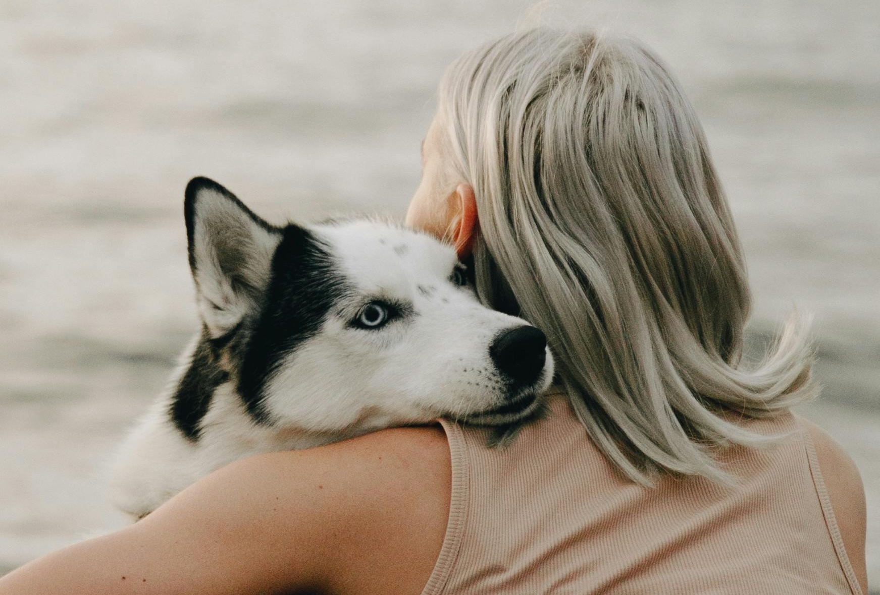 A woman and her dog sharing a quiet, intimate moment