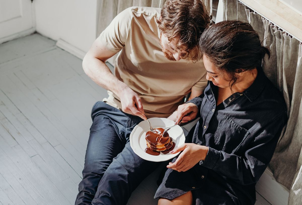 Two hands resting together on a kitchen counter, unposed and ordinary