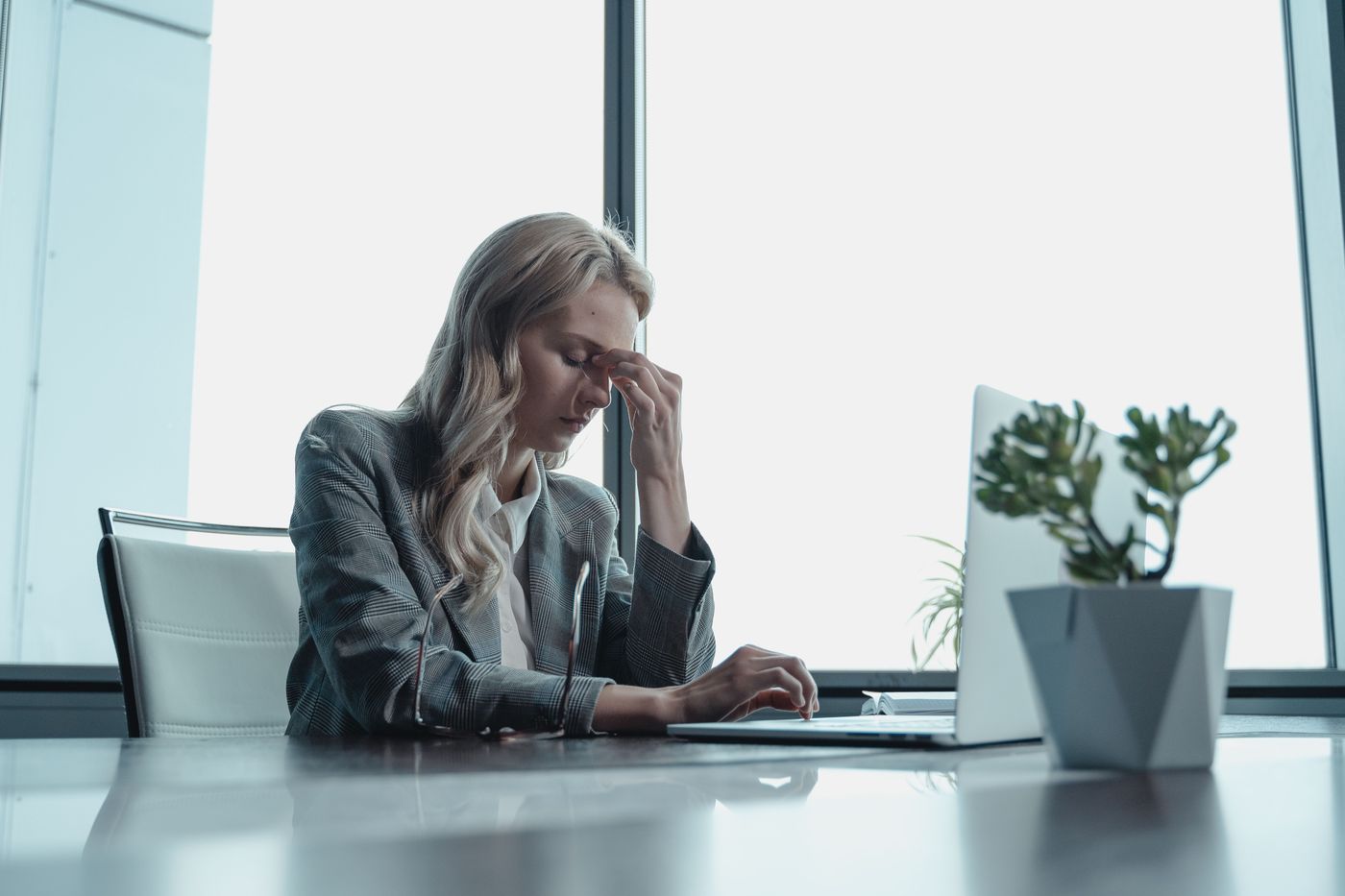 A woman sitting alone in soft light, quietly still after a long day of accommodating everyone else