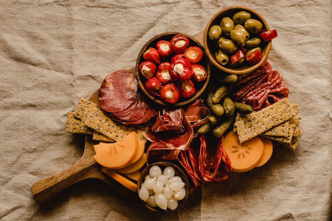 A colorful spread of fermented foods, vegetables, and whole grains on a wooden table