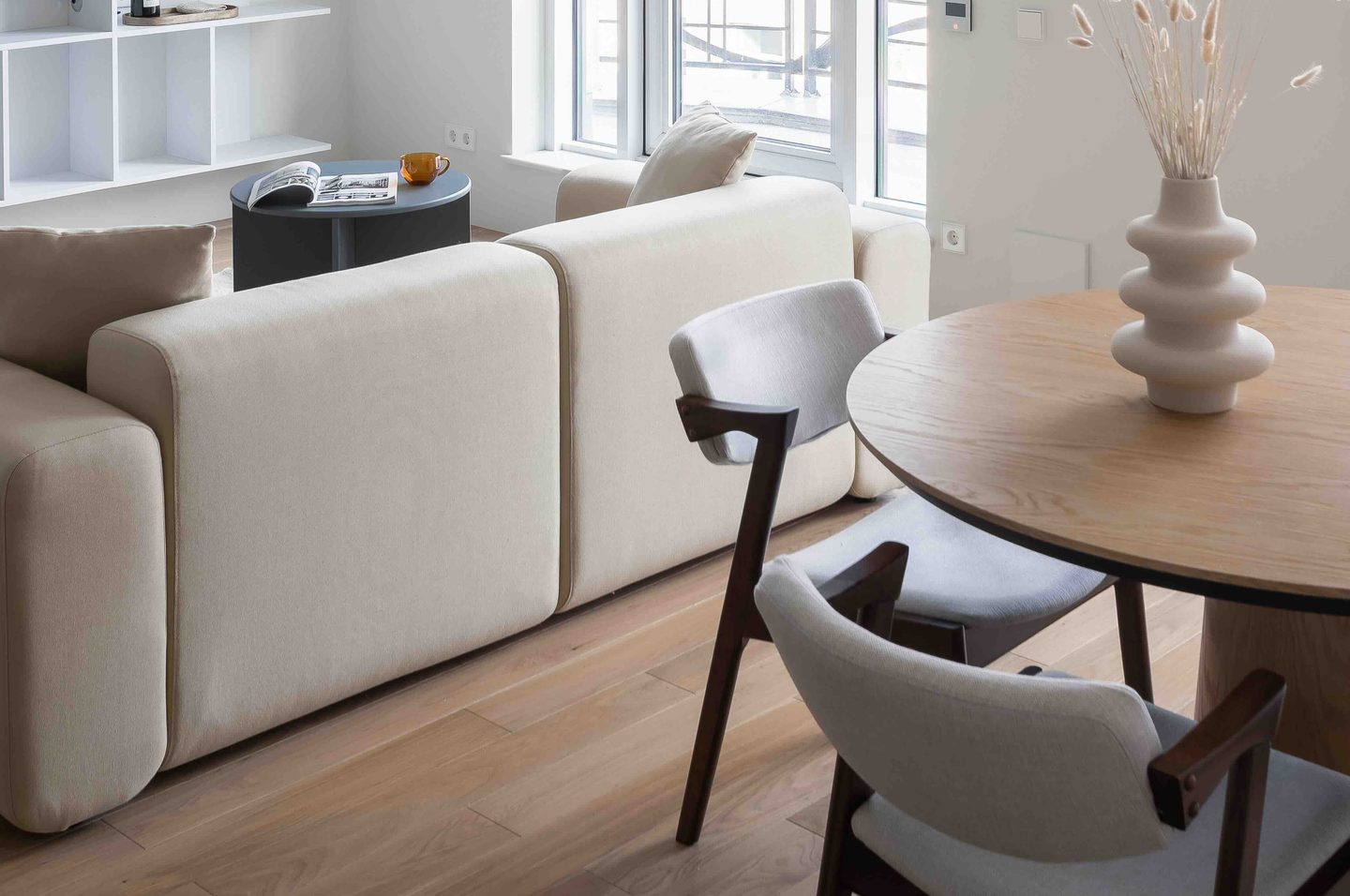 A warm, earthy living room in greige and natural wood tones