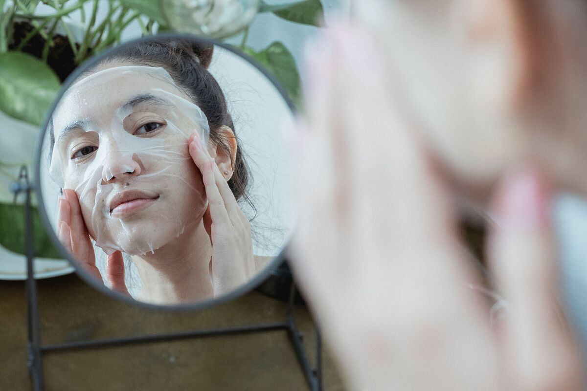 A minimal skincare routine laid out on a light marble surface