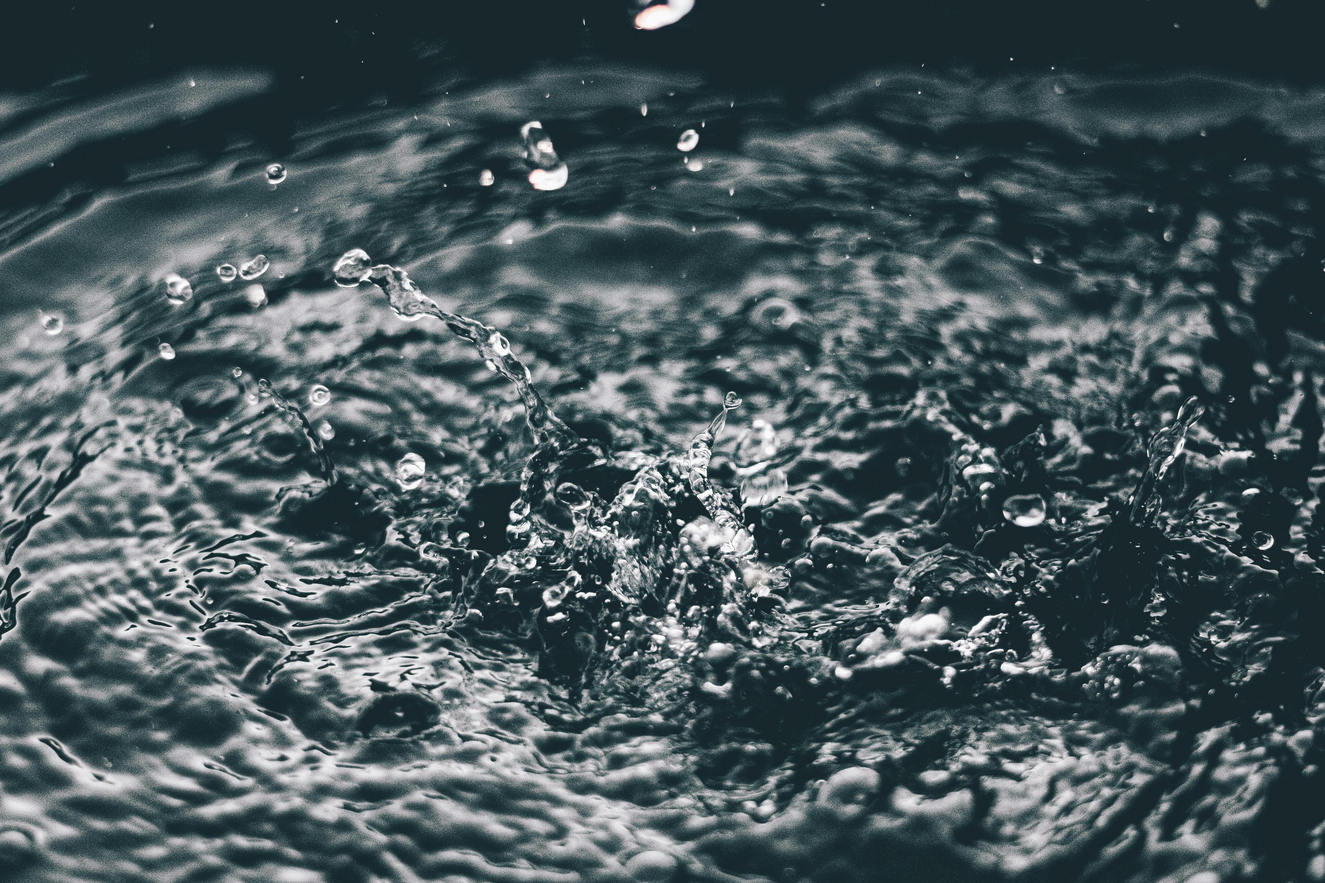 A dark moody water splash — the power of hydration