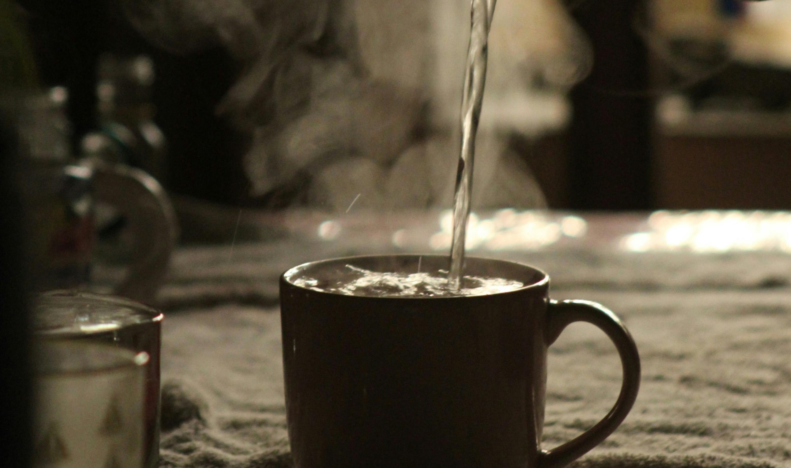 A warm mug of ACV and honey drink with steam rising