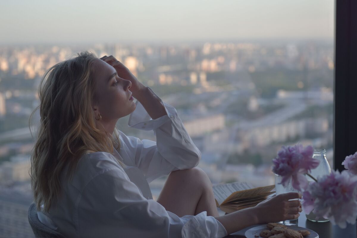 A woman alone in quiet morning light — the ordinary work of rebuilding