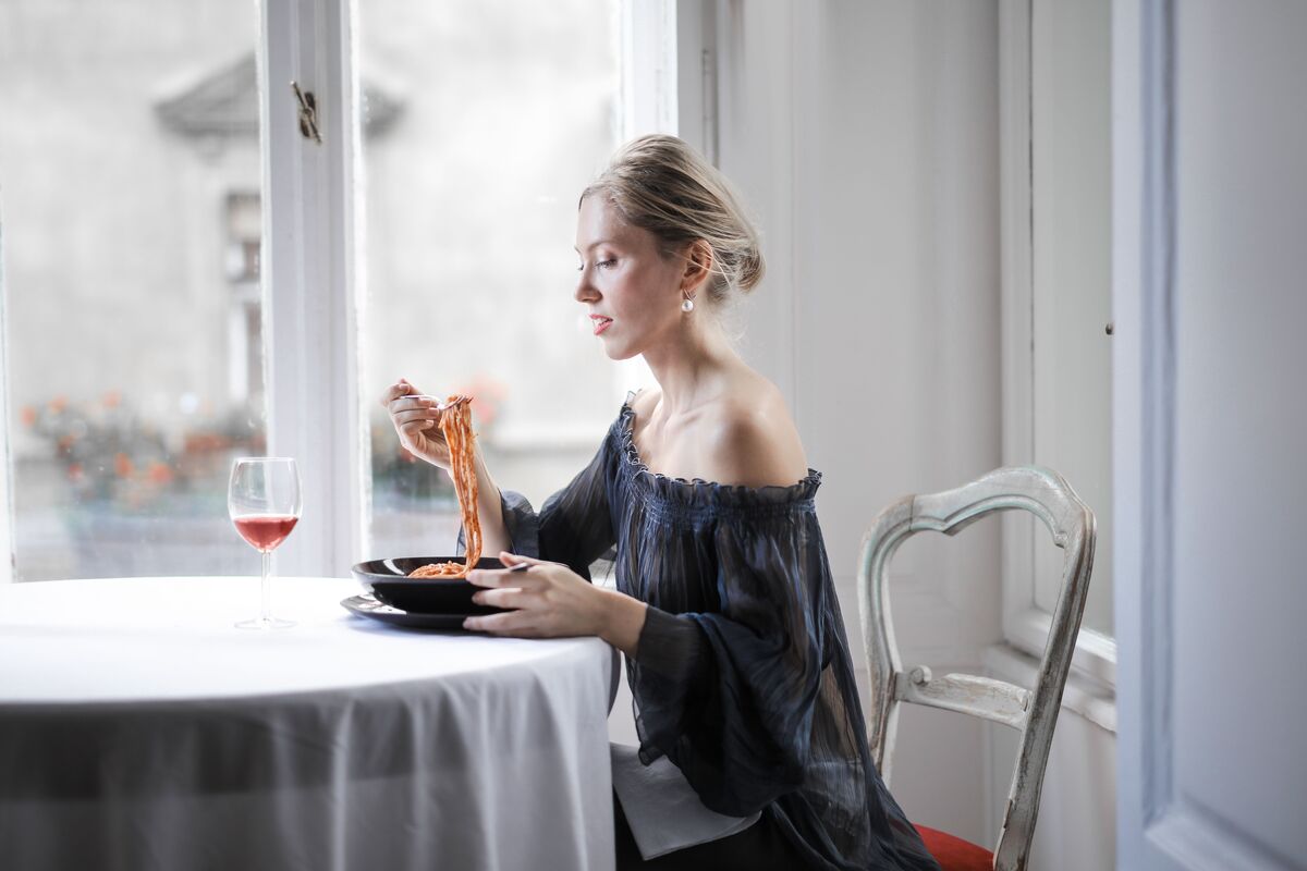 Warm evening light at a dining table set for one — the quiet ritual of a screen-free meal